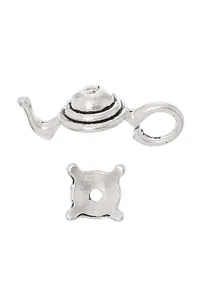 Macro view of antique silver teapot pendant and textured square base for DIY jewelry