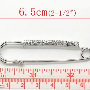 6.5cm silver safety pin brooch with sparkling rhinestones on a white background