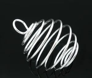 Macro shot of silver lantern coil spiral pendant with smooth mirror finish for DIY jewelry