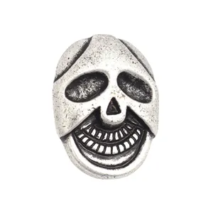 Antique silver skull-shaped metal button with 2 holes for vintage sewing and DIY crafts