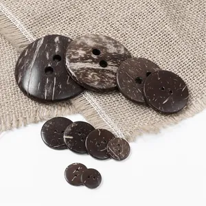 Detailed view of natural brown coconut shell buttons with two holes on burlap fabric