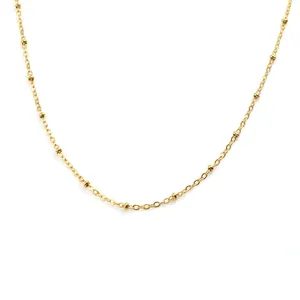 Polished golden stainless steel bead chain necklace with lobster clasp on white background