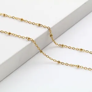 Elegant 18K gold plated stainless steel satellite bead chain necklace on white pedestal