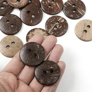 Macro shot of natural brown coconut shell buttons showing fiber texture and two-hole detail