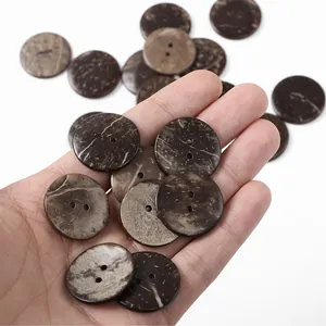 Close-up of brown coconut shell buttons with two holes and natural textured wood finish
