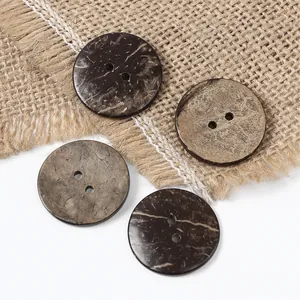 Macro detail of natural brown coconut shell buttons with dual holes on rustic linen