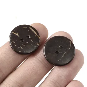 Macro detail of two-hole brown coconut shell buttons with natural wood grain texture