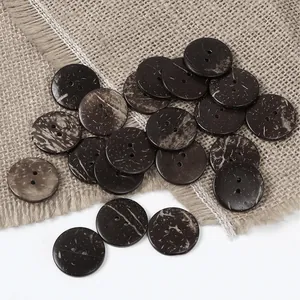Close-up of brown coconut shell buttons with two holes on rustic burlap fabric
