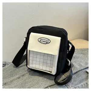 Detail of canvas crossbody bag with contrast white flap pocket and clear card slot
