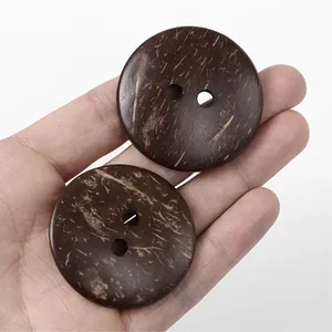 Macro detail of large brown two-hole coconut shell buttons with natural fiber texture