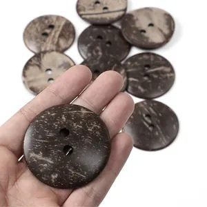 Close-up of natural brown coconut shell buttons with two holes and unique grain texture