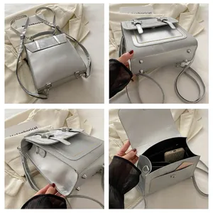 Detailsicht der silbernen Metallic-Tasche mit Bodennieten, Innenraum und Seitenprofil