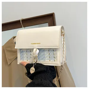 Detail of tweed flap bag with gold chain strap and Fashion Bags text on a neutral background