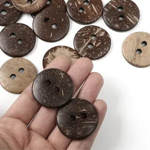 Natural brown coconut shell buttons with 2 holes and organic fiber textures on white background