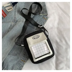 Detail of a black and white Japanese style mini crossbody bag with a transparent window