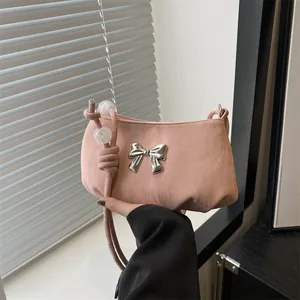 Pink shoulder bag with a silver butterfly lock and elegant beaded strap design