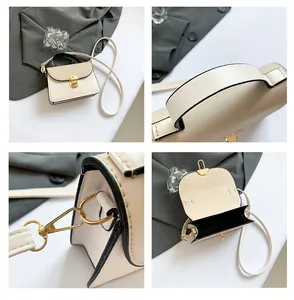 Dettaglio della borsa beige con chiusura in metallo, manico e tracolla rimovibile