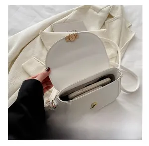 Interior view showing the storage capacity of a cream semi-circular crossbody bag