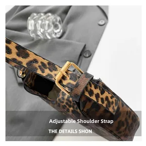 Detail of leopard print bag showing the adjustable shoulder strap and golden metal buckle