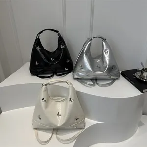 Chic hobo bags in black, silver and beige with metallic butterfly hardware accents