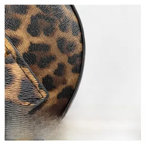 Macro detail of leopard print leather handbag showing premium stitching and fine texture