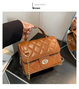 Detail of brown quilted faux leather bag featuring a gold chain and metallic twist lock