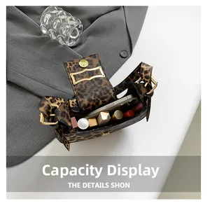 Leopard print handbag interior view showing storage for phone and cosmetics