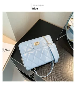 Detail of light blue quilted crossbody bag with gold twist lock and chain strap