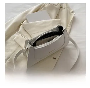 Interior view of off-white PU leather shoulder bag showing capacity and golden logo detail