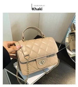 Close-up of khaki quilted leather bag with golden twist-lock and chain strap