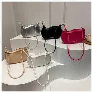 Detailed display of crescent-shaped shoulder bags in silver, black, pink, and white tones