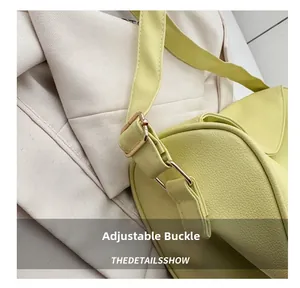 Detail of adjustable golden metal buckle on lime green textured leather shoulder bag