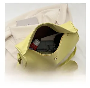Detailed interior of yellow textured leather bag showing large capacity for daily items