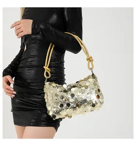 Detailed macro of large round gold sequins and yellow rope handle on evening bag