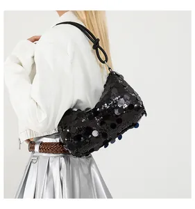 Detail of black sequined hobo bag featuring a decorative knotted shoulder strap