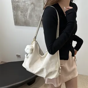 Minimalist white tote bag with cloud charm and textured fabric for daily commute