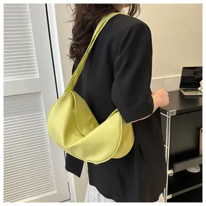 Side view of lime green croissant bag with stylish ruched design and wide shoulder strap