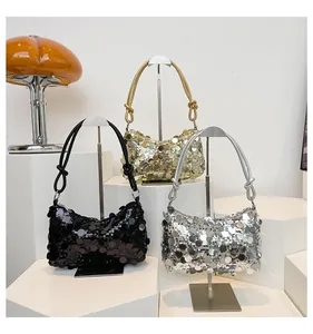 Detailed close-up of sequined crescent shoulder bags in black, gold, and silver finishes