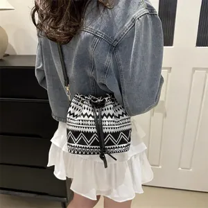 Detailed back view of a black and white geometric ethnic style drawstring bucket bag