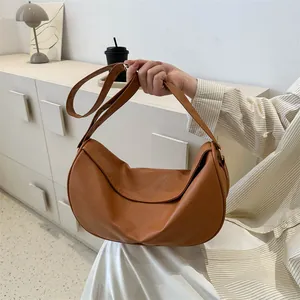 Minimalist brown crescent crossbody bag made of premium lychee texture vegan leather