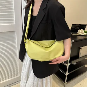 Lime green half-moon crossbody bag for women with wide adjustable strap and gold hardware