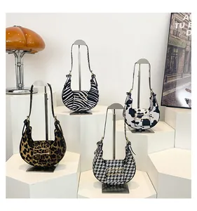Detail view of stylish leopard and zebra print saddle bags with golden buckles