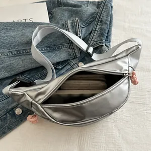 Silver waist bag showing internal capacity with long wallet and power bank inside