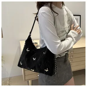 Shoulder bag in black velvet with silver butterfly charms and metal chain details
