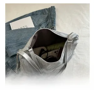 Spacious silver metallic tote showing interior capacity for glasses, wallet and umbrella