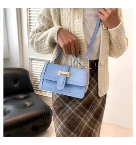 Dettaglio della borsa in pelle azzurra con stampa coccodrillo e chiusura a H dorata