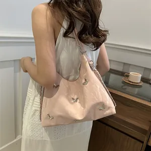 Pink pleated faux leather shoulder bag with silver butterfly charms and chain strap