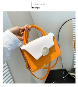 Detail of orange and beige leather handbag with water-drop clasp and handle