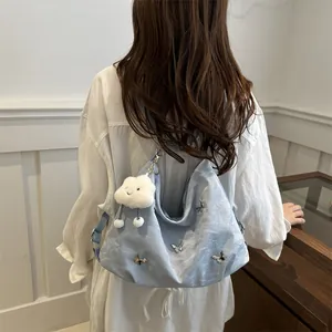 Light blue cloud-textured shoulder bag with butterfly charm and plush cloud pendant