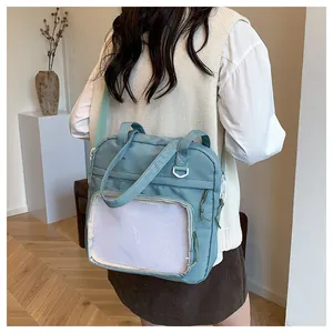 Borsa tote in tela grigio-blu con ampia finestra trasparente indossata dalla modella